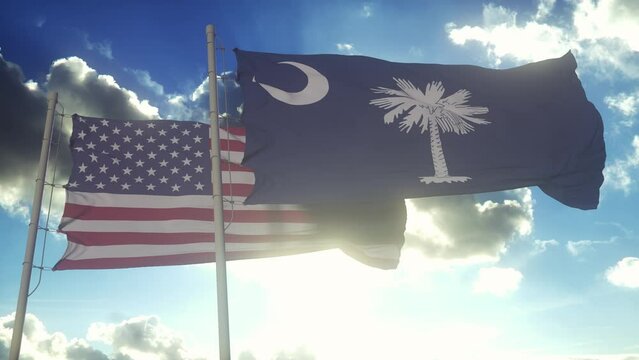 The South Carolina state flags waving along with the national flag of the United States of America. In the background there is a clear sky
