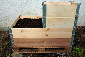 Fototapeta na wymiar Building and filling a raised bed