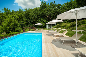 pool in country house surrounded by nature on a sunny summer day 