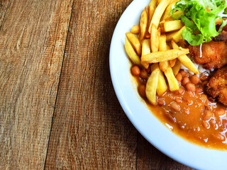 Partial view of traditional Brazilian meal known as  prato feito on the wooden table with space to...