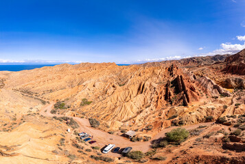 Fototapeta na wymiar landscape of Skazka canyon on Issyk-Kul lake. Rocks Fairy Tale famous destination in Kyrgyzstan. Mountain like great wall of china and Rainbow Mountains of Danxia or Antelope crevice USA, Central Asia