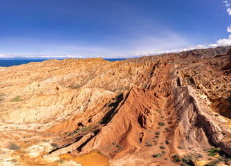 landscape of Skazka canyon on Issyk-Kul lake. Rocks Fairy Tale famous destination in Kyrgyzstan. Mountain like great wall of china and Rainbow Mountains of Danxia or Antelope crevice USA, Central Asia