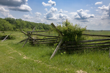 Fototapeta na wymiar Stacked wooden fence on the edge of the Gettysburg battlefield, site of the bloodiest battle of the Civil War. Pennsylvania