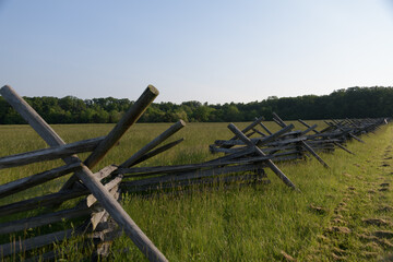 Fototapeta na wymiar Stacked wooden fence on the edge of the Gettysburg battlefield, site of the bloodiest battle of the Civil War. Pennsylvania