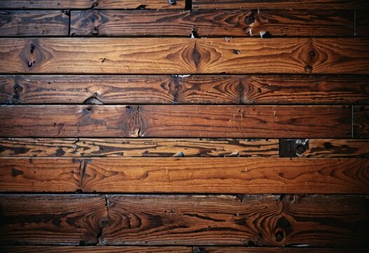 Warm, rich wooden floorboards offer a glimpse of natural textures and patterns. The detailed photograph highlights the organic beauty and craftsmanship of woodwork. AI generation
