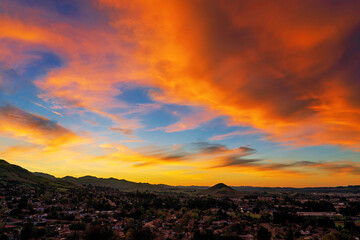 Obraz premium Sunset in the mountains with orange clouds, sky