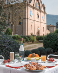 morning breakfast in an Italian hotel garden with gothic church in the background