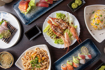 assortment of asian food from above in a dark table , 