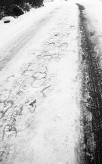 frozen driveway after the snow storm in February in black and white