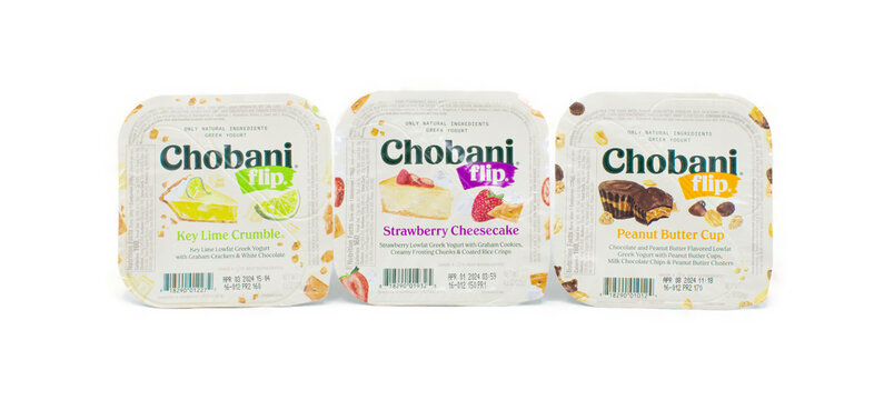 Ocala, Florida 2-29-2024 three 3 flavors of Chobani flip brand Greek yogurt,  key lime crumble, strawberry cheesecake, peanut butter cup isolated on white background