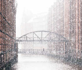 Hamburg warehouse district bridge over river in winter snow