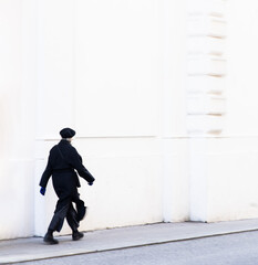 elegant dressed person walking on the street