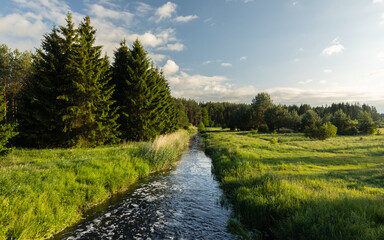 A river flowing among fields and forests in spring Podlasie 
