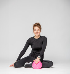 full-length portrait of a pleasant Pilates woman on a white background. sporty smiling woman in black sportswear on a white background - 749041298