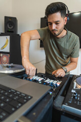 DJ having a good time while pressing buttons on the console to create music