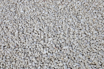 Background textured surface crushed stone, material for building and roads, Film grain effect