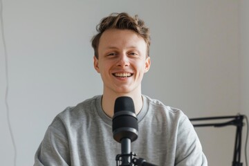 Naklejka premium Man with a cheerful smile engaging in podcast recording in a relaxed studio atmosphere