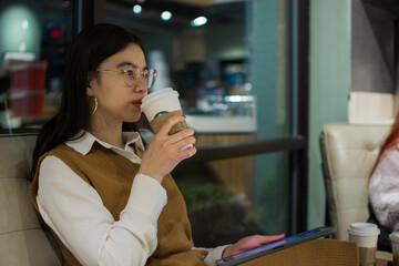 Asian girl drinking a cup of coffee
