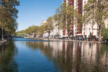 Paris, France - September 30, 2021: landscape view of the Canal Saint Martin at Paris with building facades and reflections on the water - 749052058