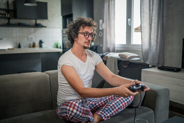 man play console video games at home hold joystick controller have fun