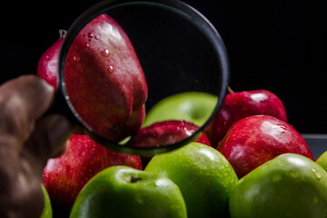 Red and green apples on a black background