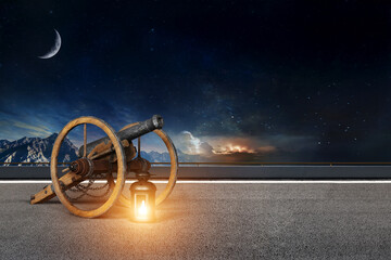 Lantern with Islamic cannon on a clear road with mountains in the background for Ramadan and Eid...