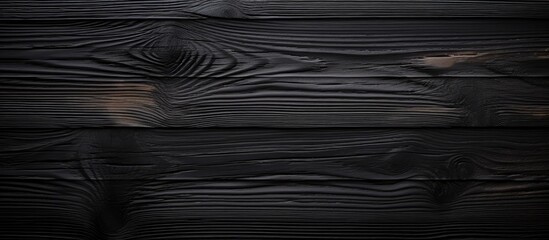 A close-up view of a black wood background featuring a detailed dark wood grain pattern. The intricate lines and textures of the wood create a visually striking and sophisticated aesthetic. - obrazy, fototapety, plakaty