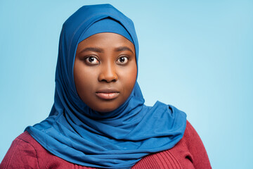 Naklejka premium Portrait serious muslim young woman wearing traditional stylish hijab, head scarf looking at camera