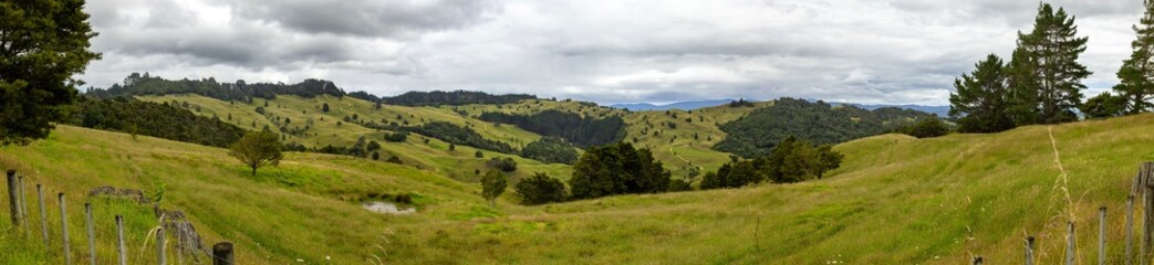 Fototapeta na wymiar Panoramic shot of rolling hills and farmland, Northland, New Zealand