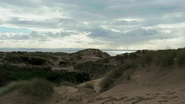 Sand dune beach view of the irish sea and wind turbines (Formby, Liverpool)