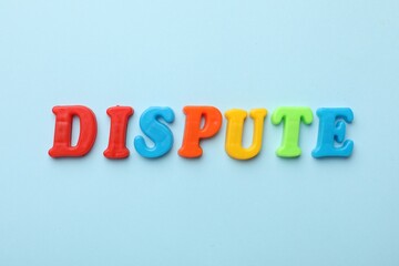 Word Dispute made of colorful letters on light blue background, flat lay