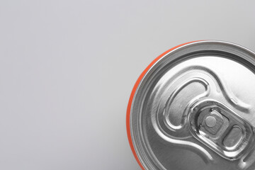 Energy drink in can on grey background, top view. Space for text
