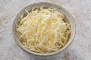 Grated Mozzarella Cheese in a Bowl - 749081830