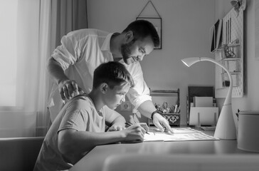 father and son do homework together - 749081881