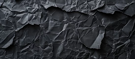 Foto op Plexiglas This image showcases a dark and aged black paper background, characterized by wrinkles, rubbed corners, and a dusty appearance. The texture adds a unique aesthetic suitable for various design projects © Emin