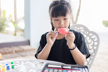 Girl painting on Easter eggs, Happy easter concept.