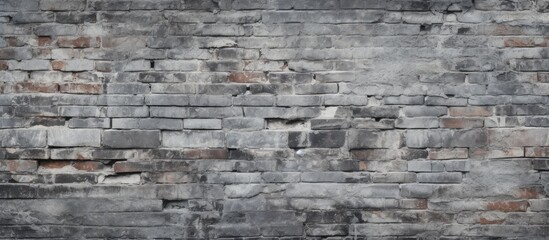 A close-up black and white photograph of a textured grey brick wall, showcasing the intricate patterns and details of the bricks.