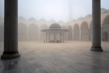 View of the courtyard and the place for ritual ablution of the Chamlyja Mosque on a foggy day,...