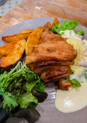 Croissant with fries and salad and cheese sauce. Serve for breakfast or lunch or dinner.