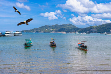 Patong Beach Phuket Thailand nice white sandy beach clear blue and turquoise waters and lovely blue skies with long tail boat
