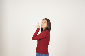 Young Asian woman in Red t-shirt Pointing up at copy space isolated on white background