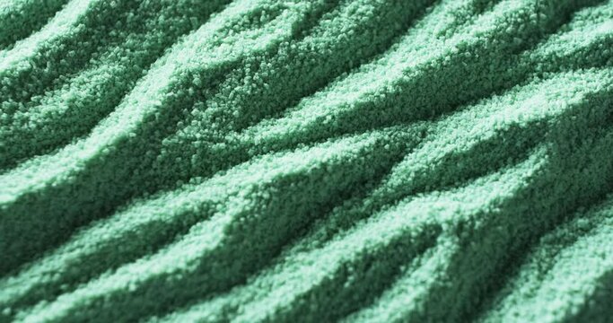 Close-up of a textured green fabric with a wavy pattern