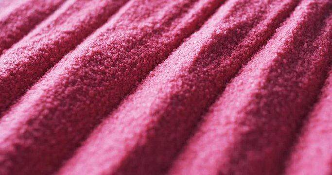 Close-up of a textured pink fabric with a ribbed pattern