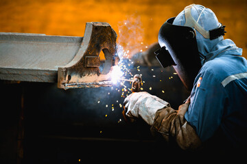 Industrial welder welding repair heavy construction part in factory, Welding process by Shielded...