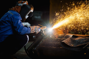 Welder use carbon air arc gouging for hot work cutting or gouging heavy metal steel structure in...