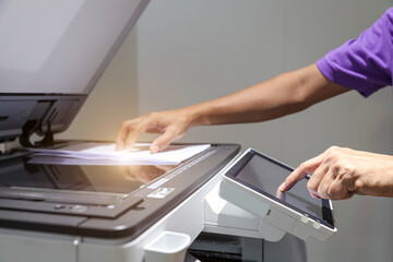 Hand use copier or photocopier or photocopy machine office equipment workplace for scanner or scanning document or printer for printing paperwork hard copy duplicate Xerox service maintenance repair. - obrazy, fototapety, plakaty