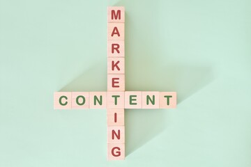 Content marketing strategy concept. Crossword puzzle flat lay typography in green background.