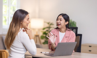 Two young asian happy business women working together for analyze planning and financial statistics and investment market  in home office space