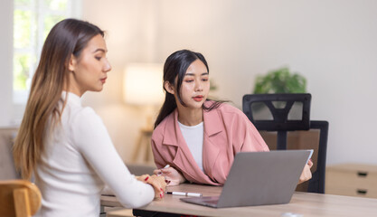 Two young asian happy business women working together for analyze planning and financial statistics and investment market  in home office space
