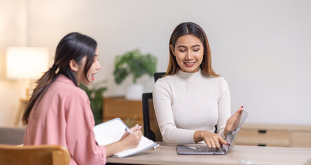 Two young asian happy business women working together for analyze planning and financial statistics and investment market  in home office space